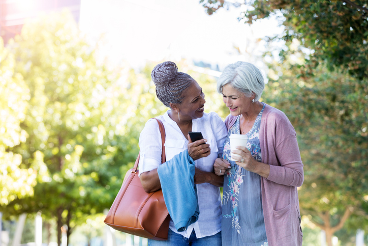 two senior women talking outdoors