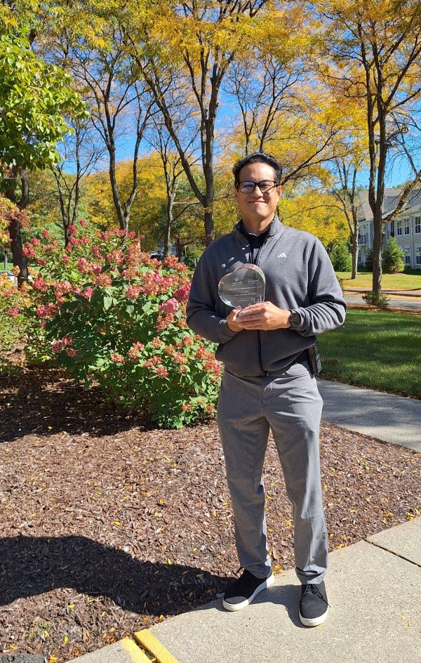 james m image outdoors with award
